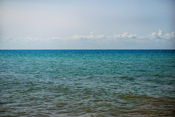 the blue ocean with dull clouds on a lovely sunny day