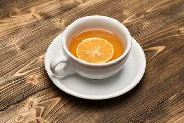 Hot beverage with sugar cubes on wooden background.