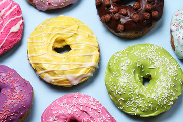 A lot of donuts on a blue background. View from above