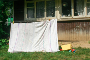 Smeared children play in nature in an improvised house. Homemade tent, hut, for fun girls and boys. Camping © SVIATLANA