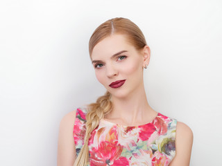 Beauty portrait of young beautiful cheerful young fresh looking woman with bright trendy make up blond healthy hair braid hairstyle.