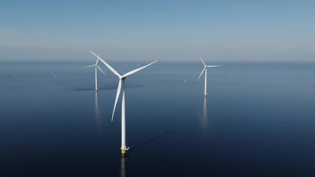 Offshore Windmill farm in the ocean  Westermeerwind park , windmills isolated at sea on a beautiful bright day Netherlands Flevoland 