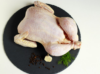 fresh chicken carcass on wooden table