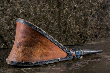 Old pair of bellows on stone background