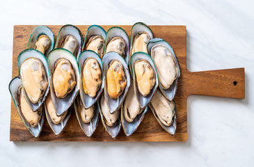 fresh mussel on wood board © topntp