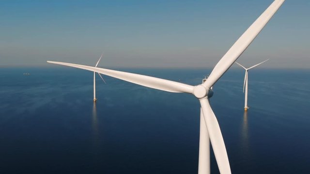 Offshore Windmill farm in the ocean  Westermeerwind park , windmills isolated at sea on a beautiful bright day Netherlands Flevoland 