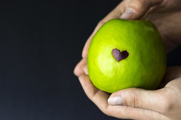 green apple in hand, fruit in hands