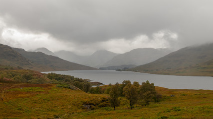 Panorama view of Loch Arklet with gathering autumnal storm clouds and the first signs of rain, near Stronachlachar, Loch Lomond & The Trossachs National Park, Scotland