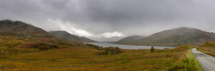 Panorama view of Loch Arklet with gathering autumnal storm clouds and the first signs of rain, near Stronachlachar, Loch Lomond & The Trossachs National Park, Scotland