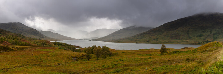 Panorama view of Loch Arklet with gathering autumnal storm clouds and the first signs of rain, near Stronachlachar, Loch Lomond & The Trossachs National Park, Scotland
