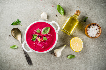 Vegan food, summer cold Beetroot gazpacho soup with lemon, avocado and fresh herbs copy space top view