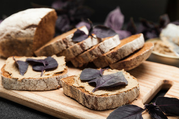 Duck pate on bread, antipasti appetizer.