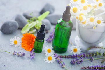 aromatherapy oil with fresh herbs and flowers