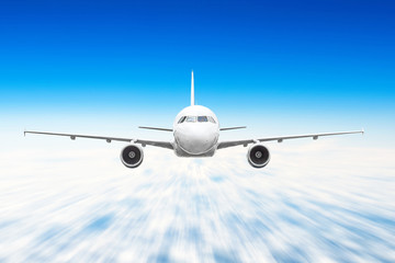 Airplane in the sky above the clouds flight journey sun height speed motion blur.