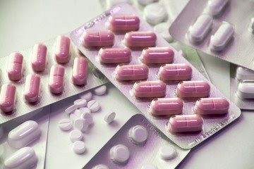 Blisters with pills on white background