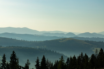 Beautiful early morning with fog between mountains