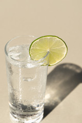 Glass of drinking water with slice of lime