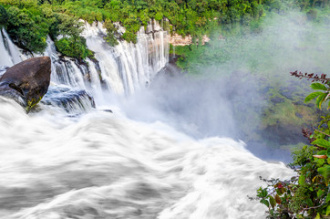 Kalandula waterfalls of Angola in full flow with lush green rain forest, rocks and spray, Africa