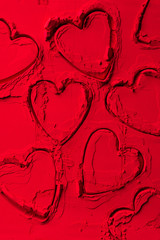 Obraz premium top view of shapes of cookie cutters in shape of hearts on red powder