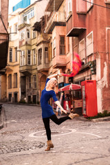 Fototapeta na wymiar Beautiful girl in front of traditional colorful houses at Balat area. Istanbul