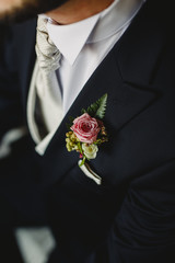 Groom dressing to go to his wedding