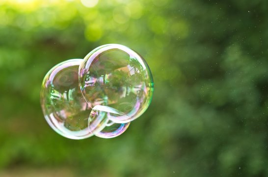 Flying soap bubbles close up. Outdoors