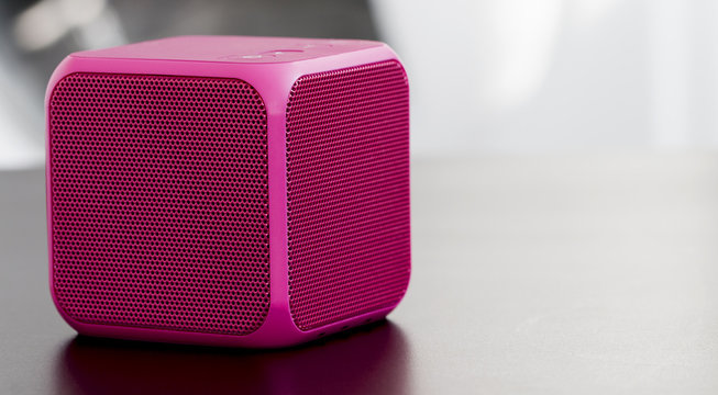 Pink bluetooth speaker cube close-up 