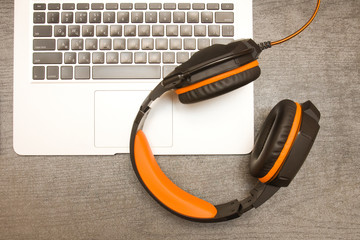 Laptop keyboard and headphones. Workplace. Top view