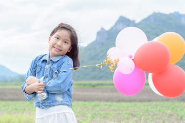 cute asian girl smile and holding balloon.