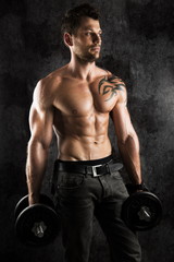 Fototapeta na wymiar adult sexi man with muscle and dumbbells on black backround