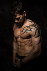 Naklejka premium adult sexi man with muscle on black backround