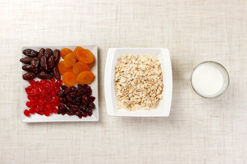 oatmeal with milk and dried fruit. Useful and healthy breakfast. light background