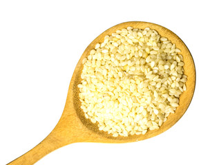 White sesame in a wooden spoon