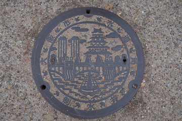 Osaka, Japan-April 9, 2017 : Drain cover with Osaka icon on pavement ,Osaka, Japan