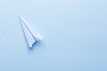 Paper airplane on light blue background