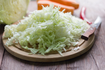 white cabbage cut into strips and carrots for cooking