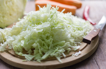 white cabbage cut into strips and carrots for cooking