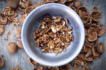 Walnuts kernels with color background, Whole walnut in a metal plate. Walnuts. Walnuts an market. Background of walnuts. Healthy. Fresh