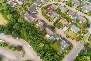 Aerial view of a suburb with detached houses, semi-detached houses and terraced houses with small front gardens and green lawns in northern Germany