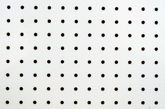 Symetrical holes on a white pegboard