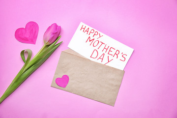 Beautiful tulip and card with text HAPPY MOTHER'S DAY on color background