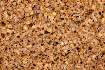 Fresh baked bread or bun with sesame on wood background