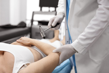 Orthopedist examining patient in hospital