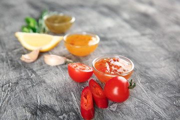 Different sauces on grey textured background