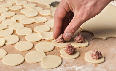 Man preparing handmade meat dumplings