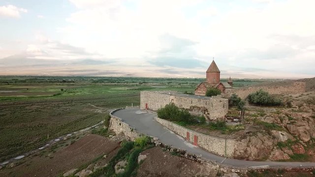 Aerial view of 17th century monastery Khor Virap from a drone flying over agricultural field on the border of Armenia next to Mt Ararat. Ararat Province, Armenia.