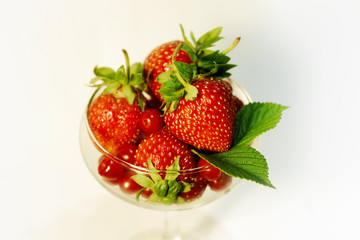 strawberries and Chinese cherries in a glass