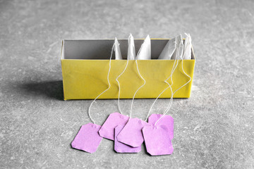 Box with tea bags on table