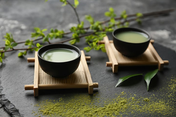 Bowls of fresh matcha tea on slate plate