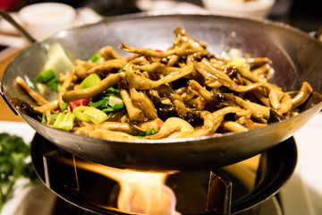 Stir fried Chinese mushrooms cooking in a wok